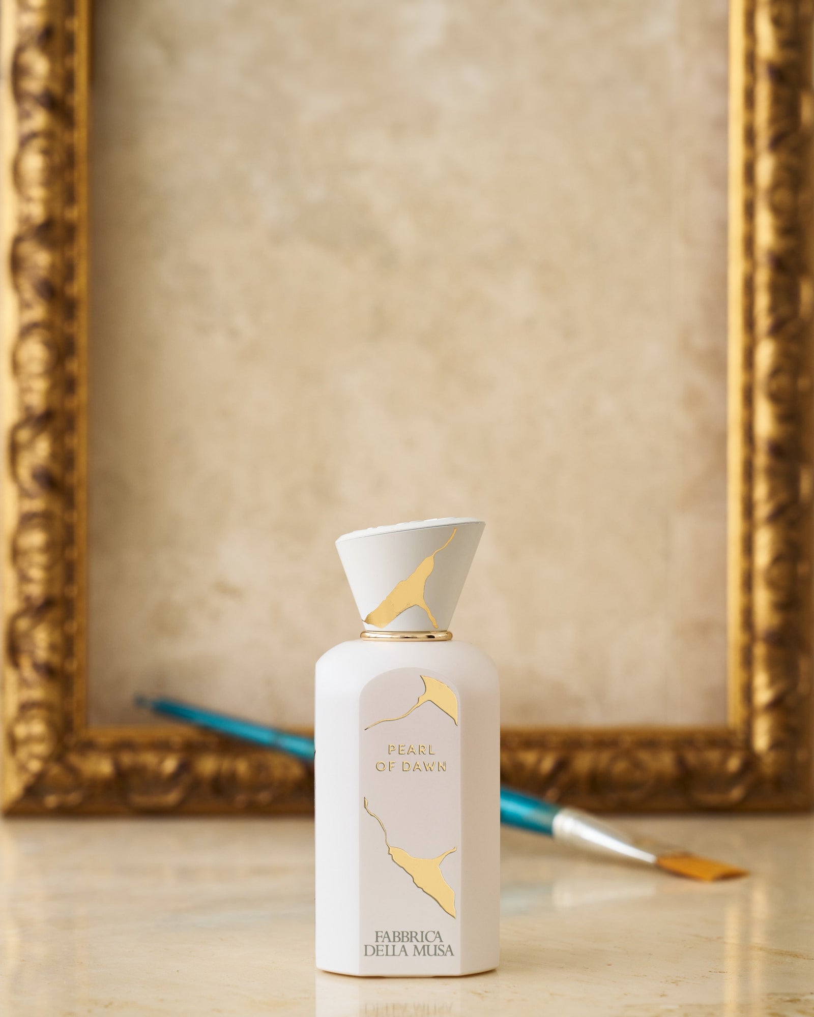 Fabbrica della Musa Pearl of Dawn 100ml bottle in a gilded frame with an artist's brush